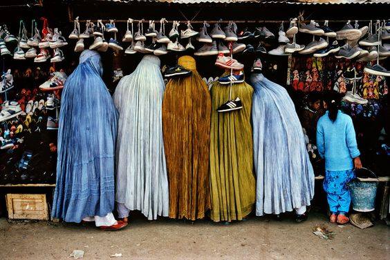 Afghan women at shoe store’, 1992. | 24 Striking Pictures Of Afghanistan By Photojournalist Steve McCurry- Balkan War was raging on